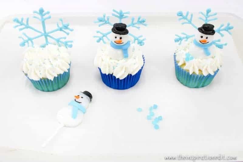 decorating snowmen on cupcakes