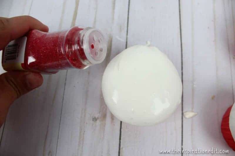 putting sprinkles on your santa cupcakes