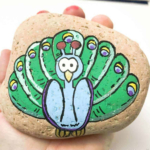 peacock painted on a rock stone.