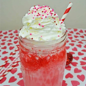 Strawberry ice cream float in a glass jar.