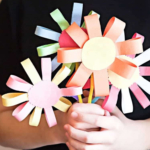 Spring paper flower in child hands.