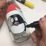 Making milk bottle penguin craft.
