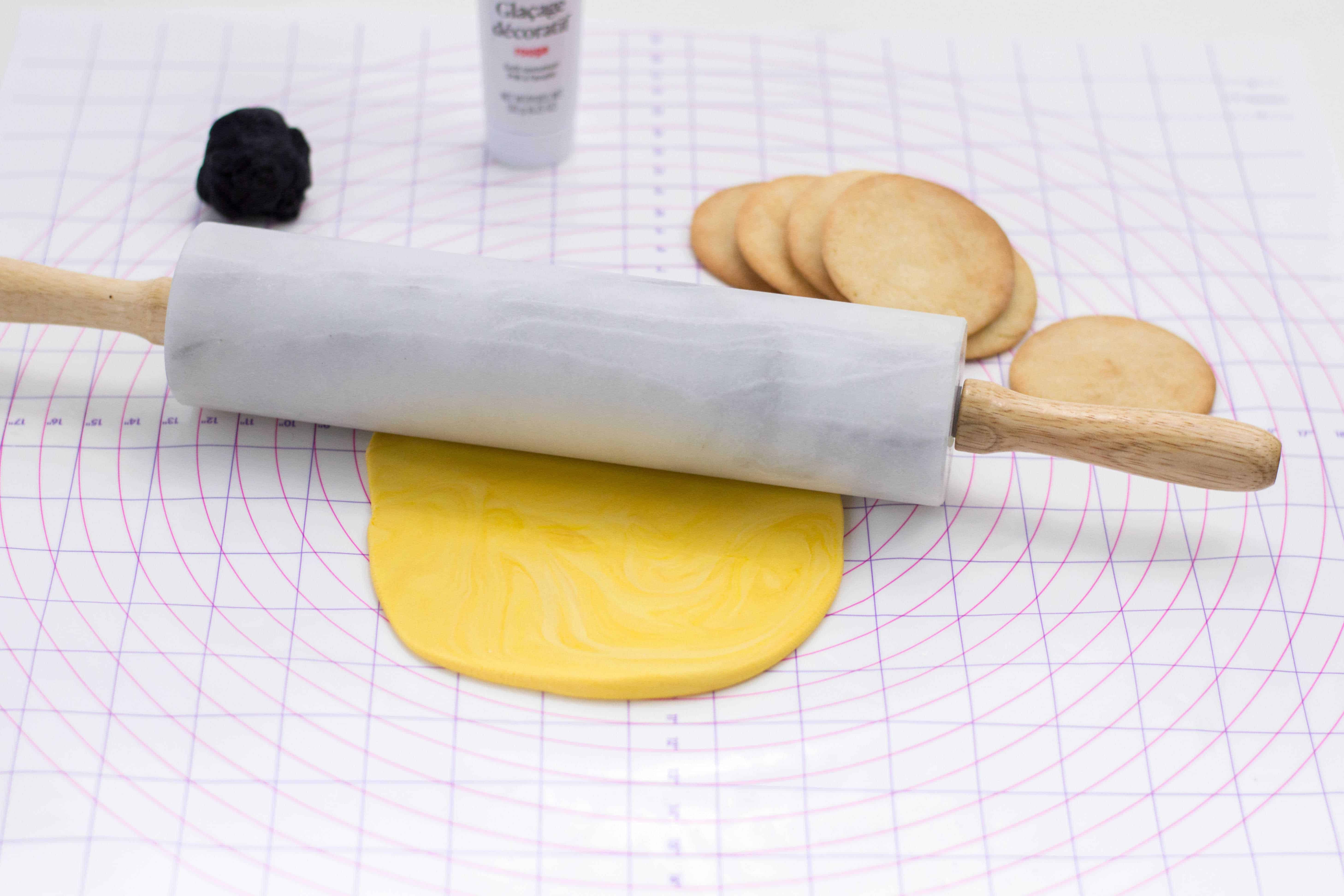 Rolling yellow fondant.