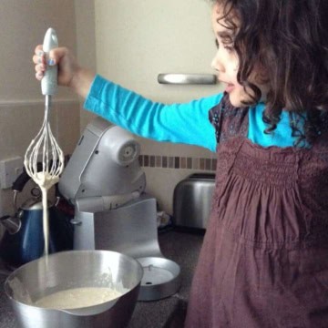 A little girl preparing pancake batter.
