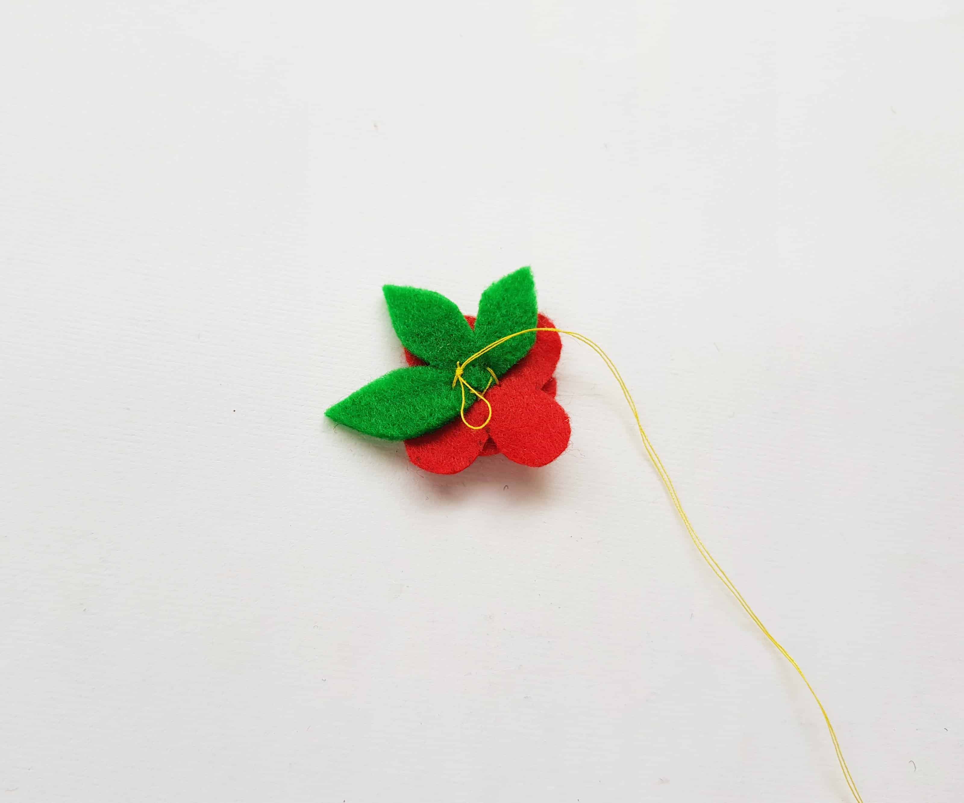 Sewing Leaves onto a Poppy.