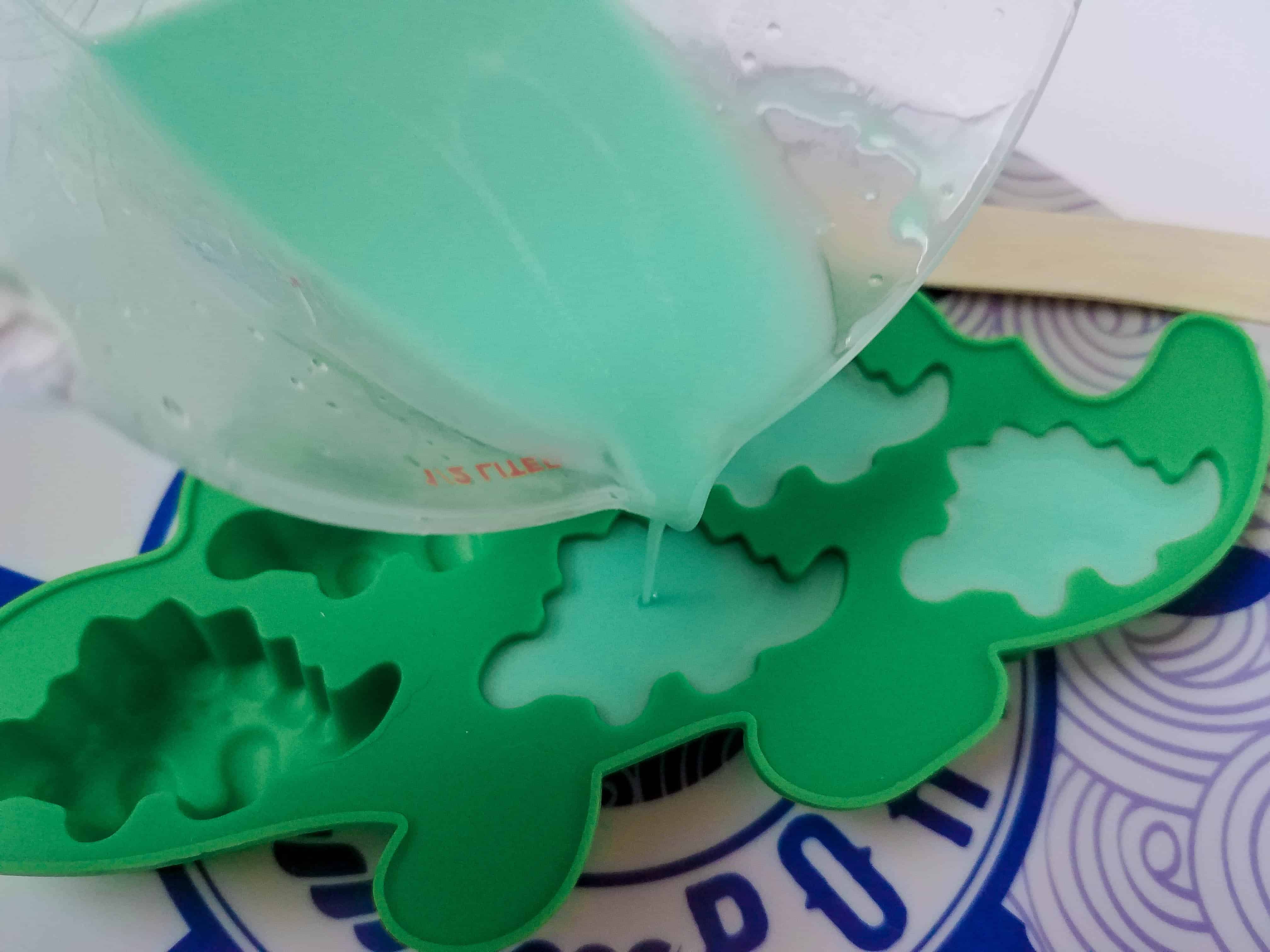 Pouring Liquid Soap into Dinosaur Mold.