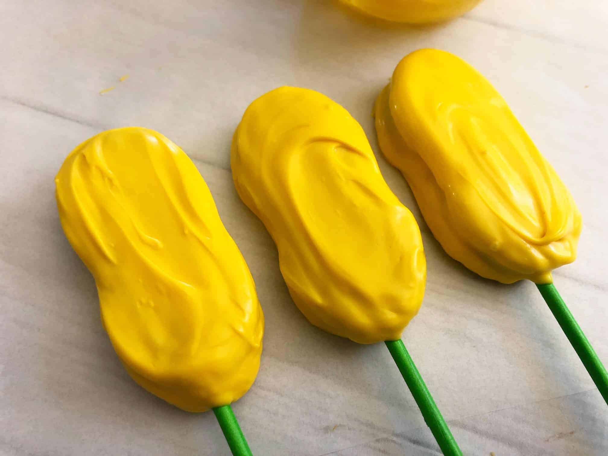 Cookies dipped in yellow candies melts.