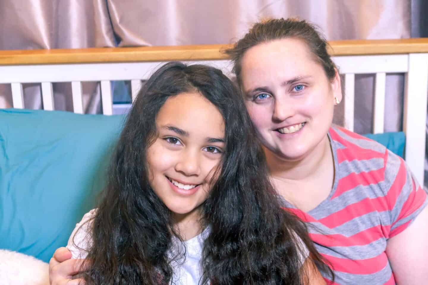 photo of angela and sylvia milnes sitting on a bed