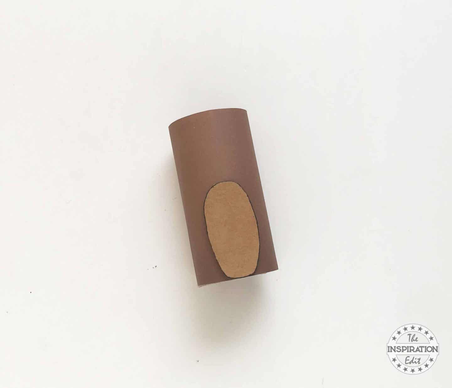 Glueing a piece of Craft Dog to Tissue Paper Roll.