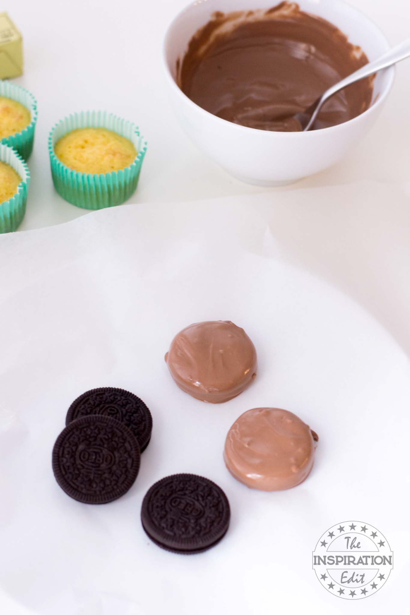 Coating Oreos with melted chocolate.