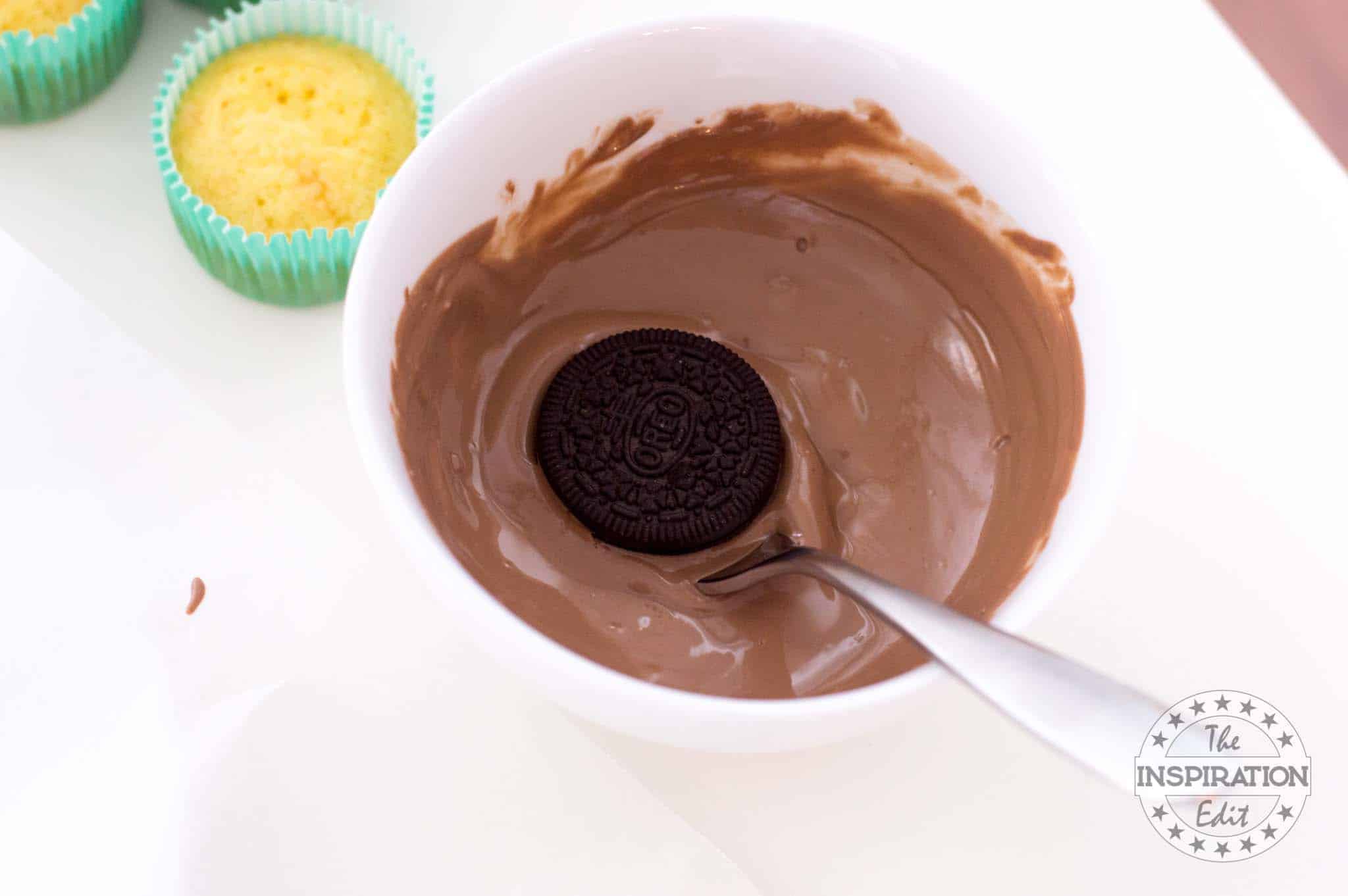 Coating Oreos in melted chocolate.