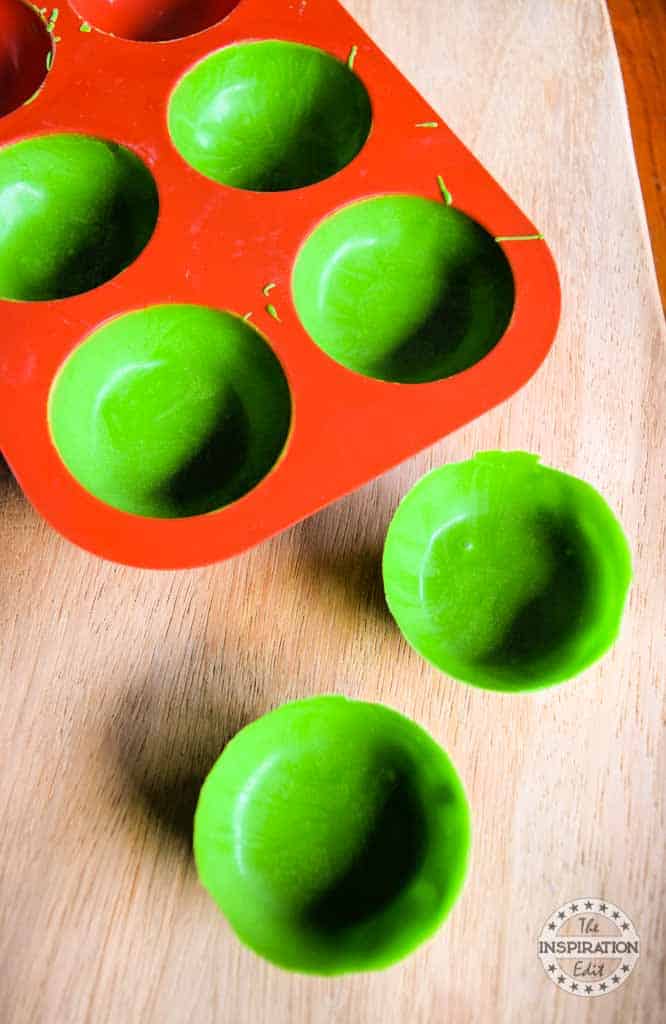 Silicone molds coated with melted green wafers.
