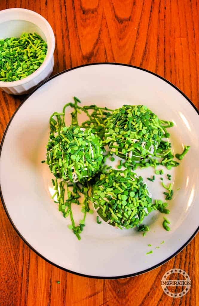 Green cocoa bombs served on a tray.