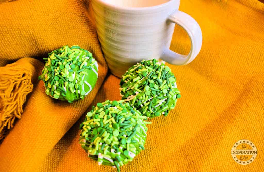 Cocoa bombs served with a mug of hot milk.