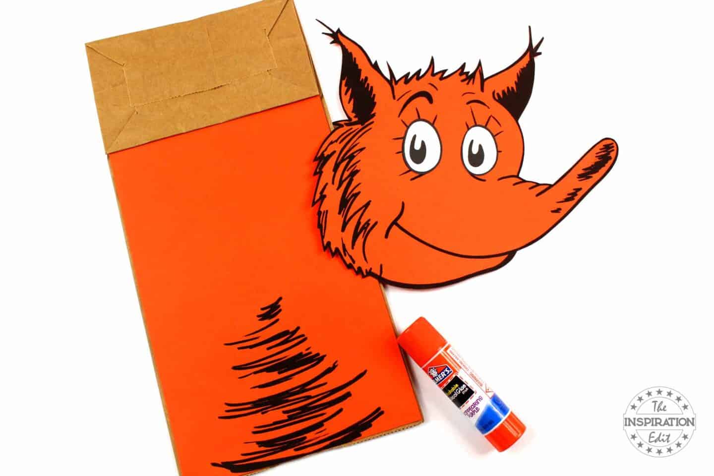 glue orange paper to fox in socks paper bag