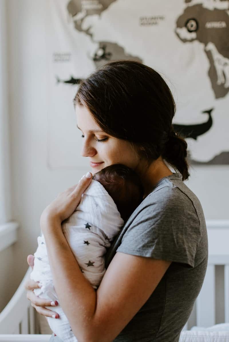 Mother holding newborn baby.