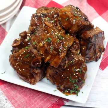 Asian lamb chops on a white plate.