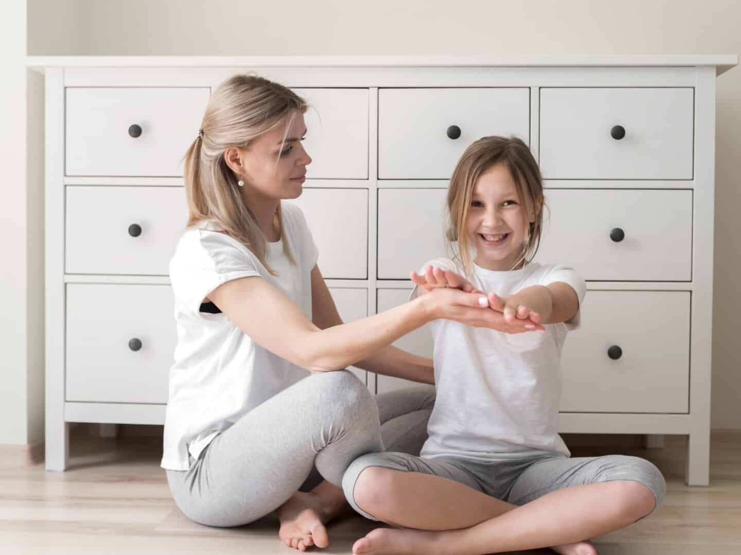 A child placing her hands on her mother's palm.