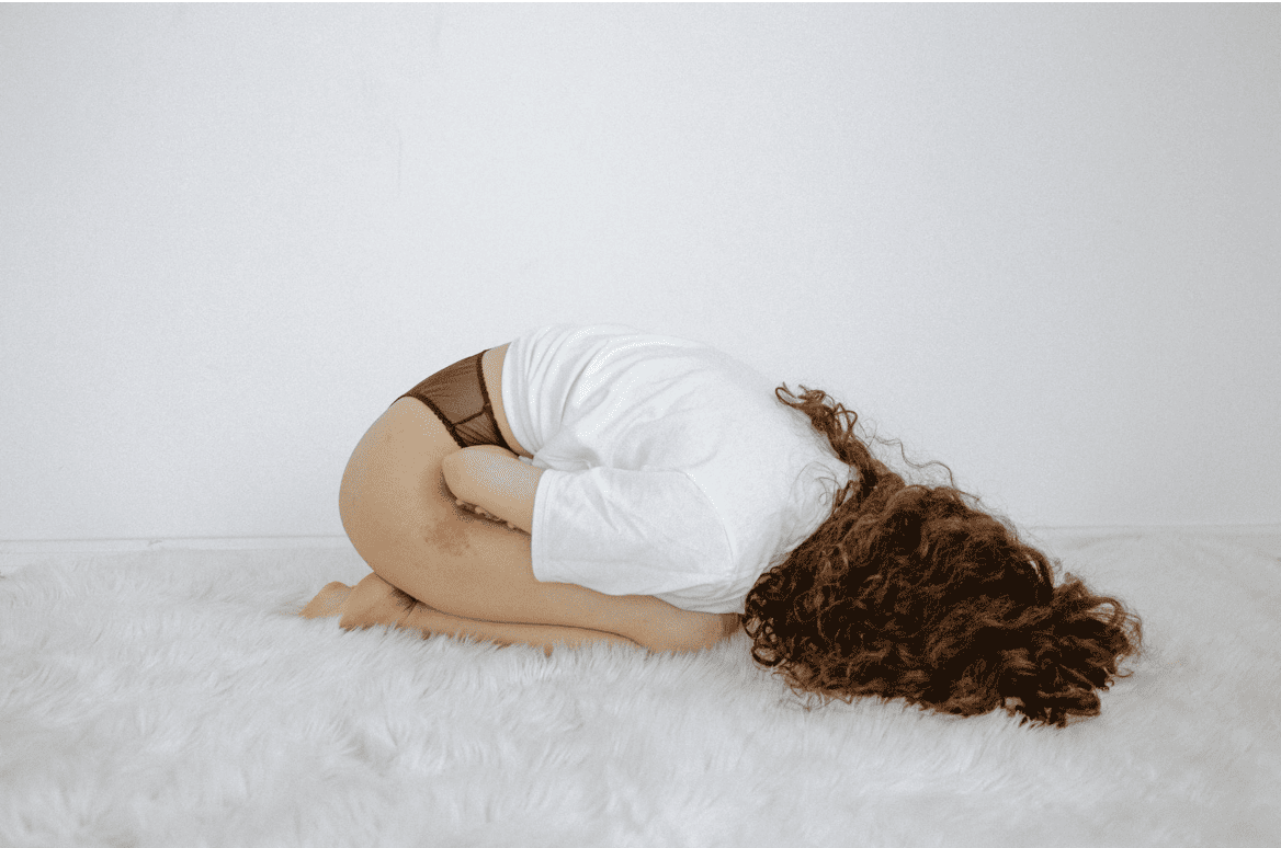 Woman Curled Up on the Floor.