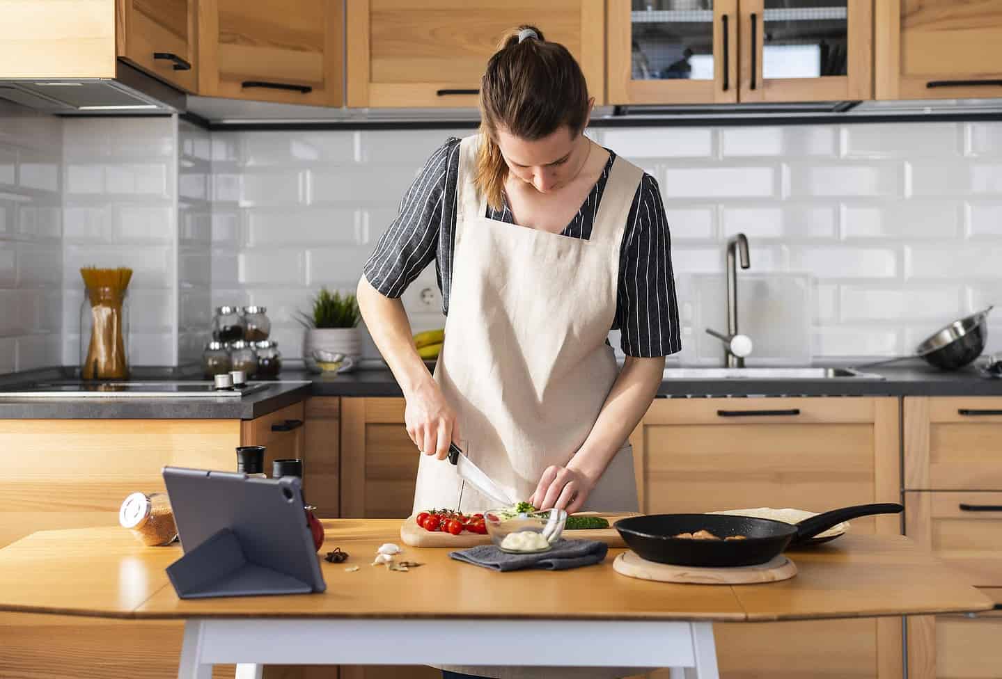 Lady Cooking in Kitchen.