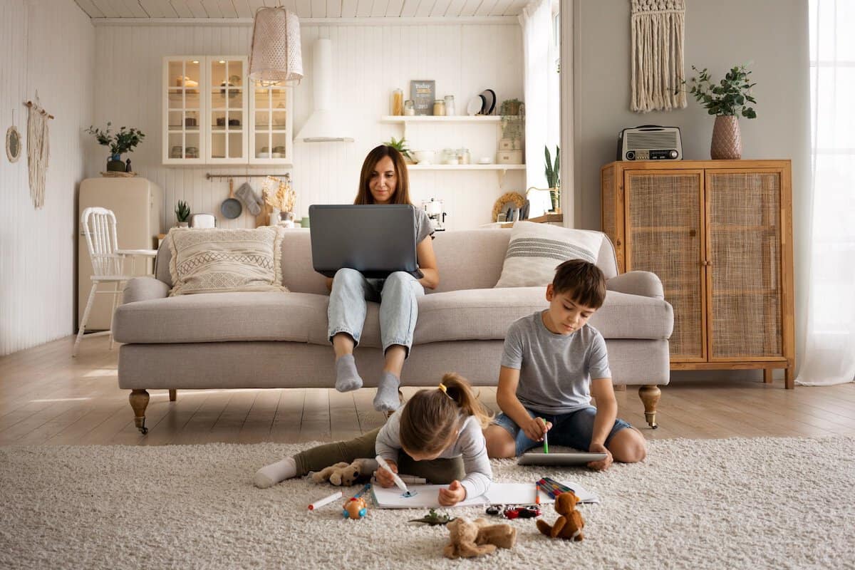 Beautiful And Family-Friendly Home | mother working Laptop While Kids are playing.