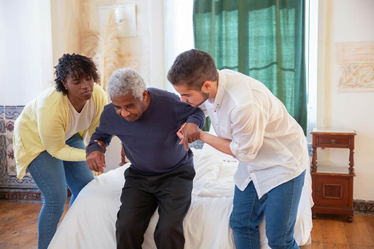 Empathy And Resilience In Caregiving | Helping an old man to stand up or sit down.