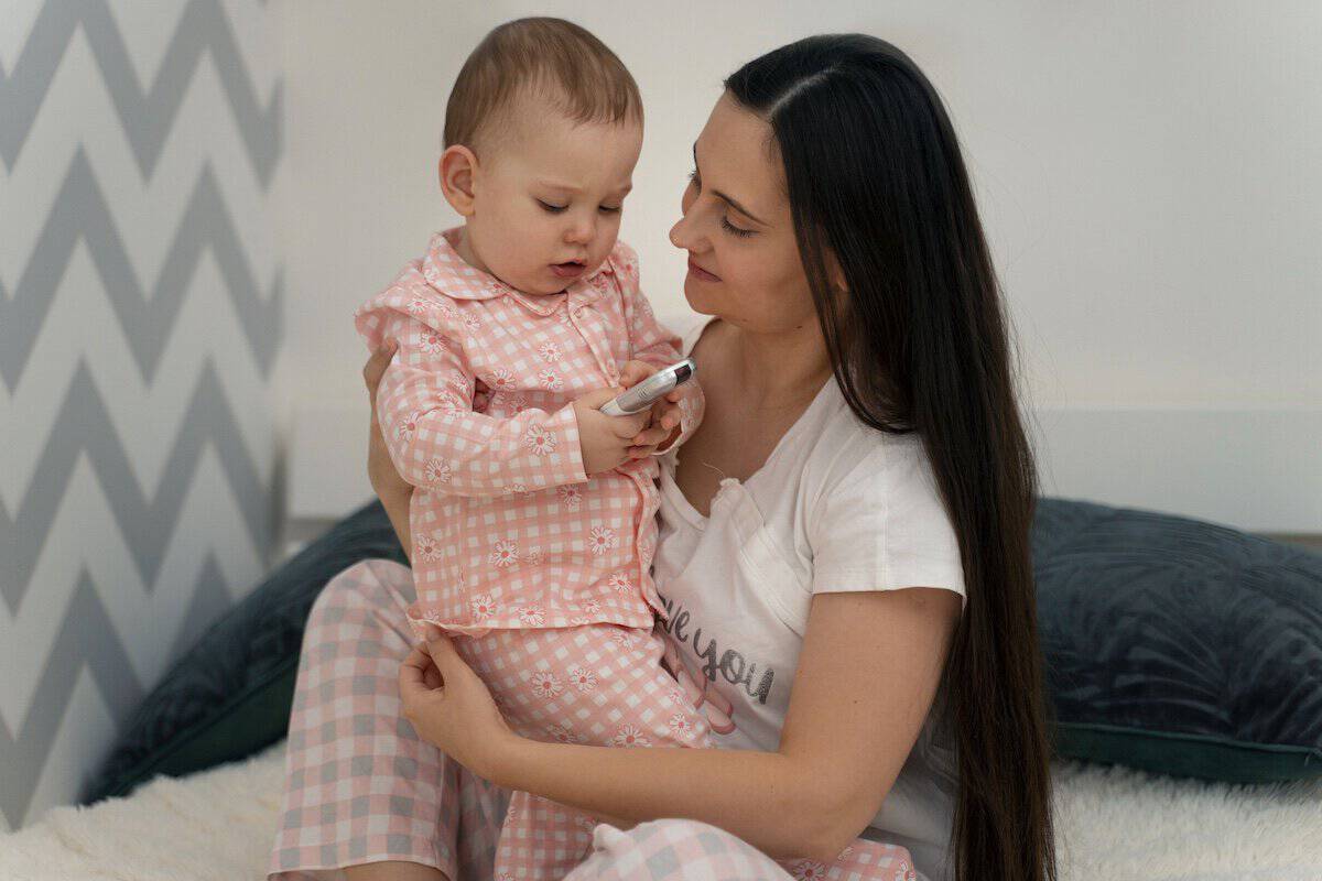 Breast Lifts in Post-Pregnancy | A Mom holding her baby.