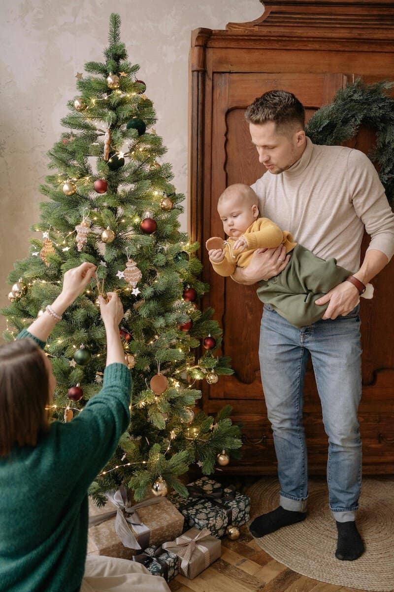 Navigating Holiday and Special Occasion | A Family putting up the Christmas Tree.