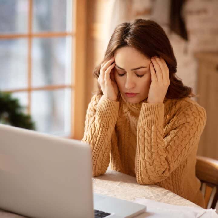 Stress Relief in the Digital Age | Woman with long hair suffering from headache.