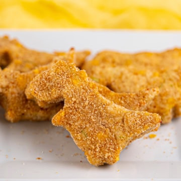 Dinosaur Turkey Nuggets on a white platter.