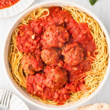 Einkorn Spaghetti and meatballs on a white plate.